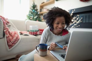Woman using her credit card to shop online during the holidays